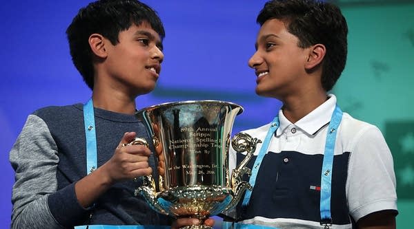 Spellers Nihar Saireddy Janga (L) of Austin, Texas and Jairam Jagadeesh Hathwar (R) of Painted Post, New York hold a trophy after the finals of the 2016 Scripps National Spelling Bee.