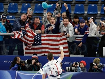 A curler celebrates with fans