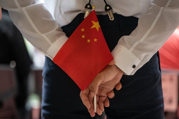 A person holds a Chinese national flag during a flag-raising assembly marking the 24th anniversary of the establishment of the Hong Kong Special Administrative Region on July 1, 2021 in Hong Kong, China. 