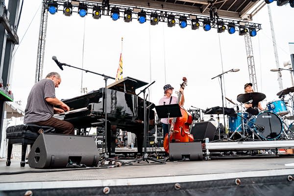 Larry Goldings Trio performing on an outdoor stage.