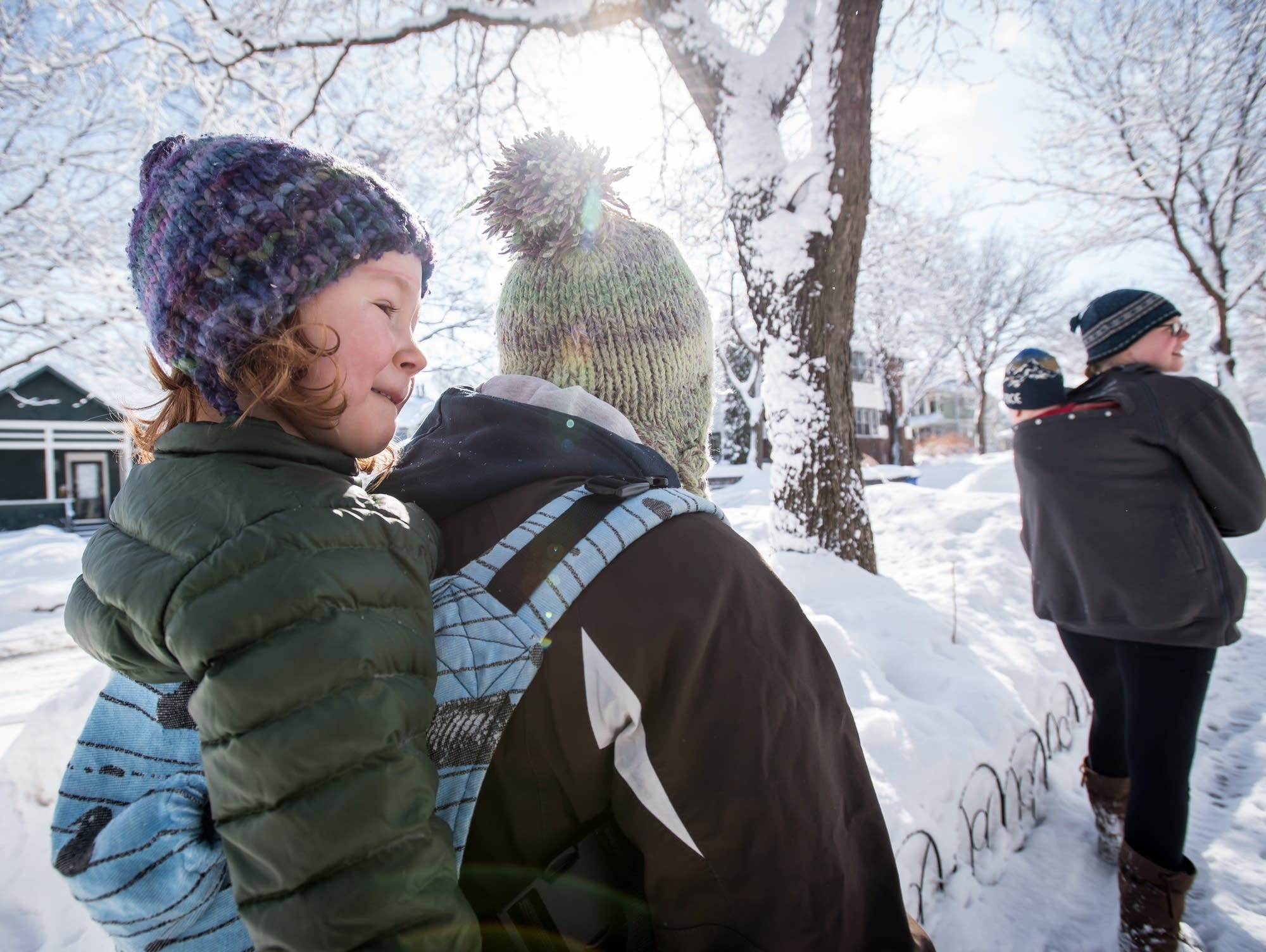 Grace Blanchard-Hinz, 4, rides on her mom Colleen Hinz's back