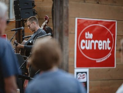Wild Horses perform on an outdoor stage.