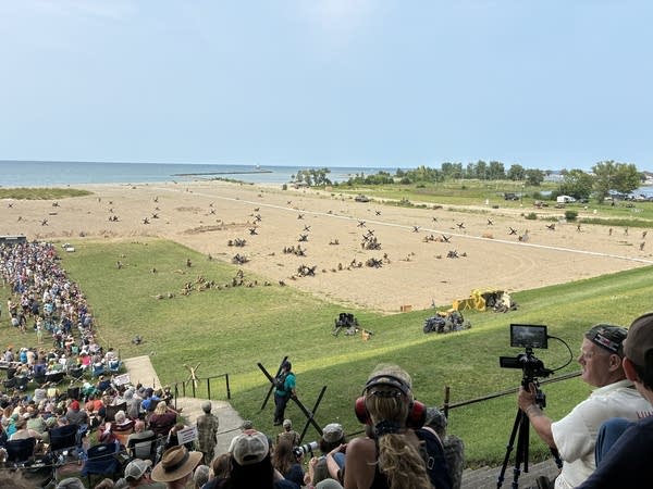 A large swath of beach at Lake Erie is covered in tank traps and trenches, surrounded by tens of thousands of spectators before the main event begins.