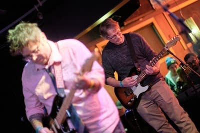 Two musicians performing onstage