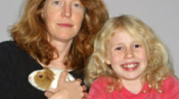 Bonnie Nevel with her daughter and guinea pigs.