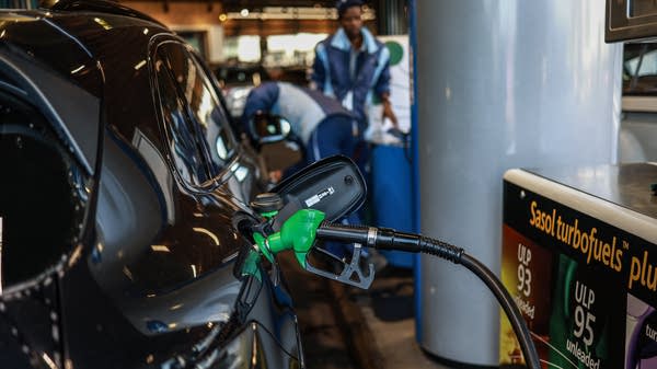 A car is refueled at a gas station.