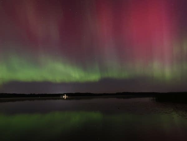 The northern lights fill the sky in shades of green, purple and red