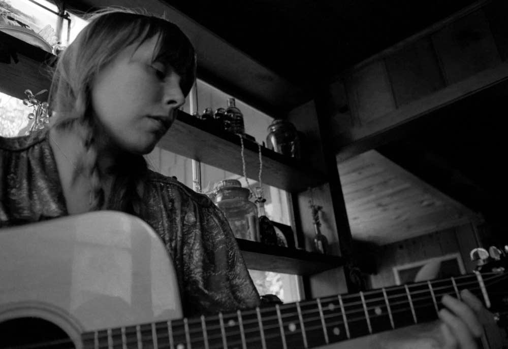 Joni Mitchell playing her guitar, 1970