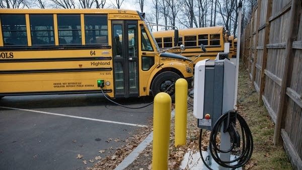 A Beverly Public Schools electric school bus charges in the parking lot. The district will get three more electric buses in spring.