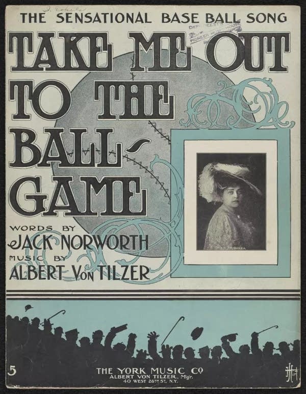 Poster A poster that says 'Take Me Out to the Ball Game' featuring a picture of a woman with a broad rimmed hat