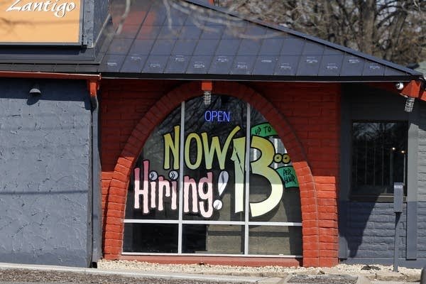 A window message for hiring at a Mexican fast-food restaurant