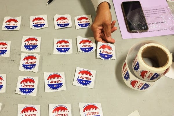 NEW YORK, NEW YORK - JUNE 22: A poll worker lays out "I Voted" stickers on a table during the Primary Election Day at P.S. 249 The Caton School on June 22, 2021 in the Flatbush neighborhood of Brooklyn borough in New York City. This is the first year in the city for ranked-choice voting, which allows voters to rank their top five candidates.