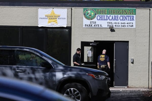 Two federal agents walks around into a childcare center.