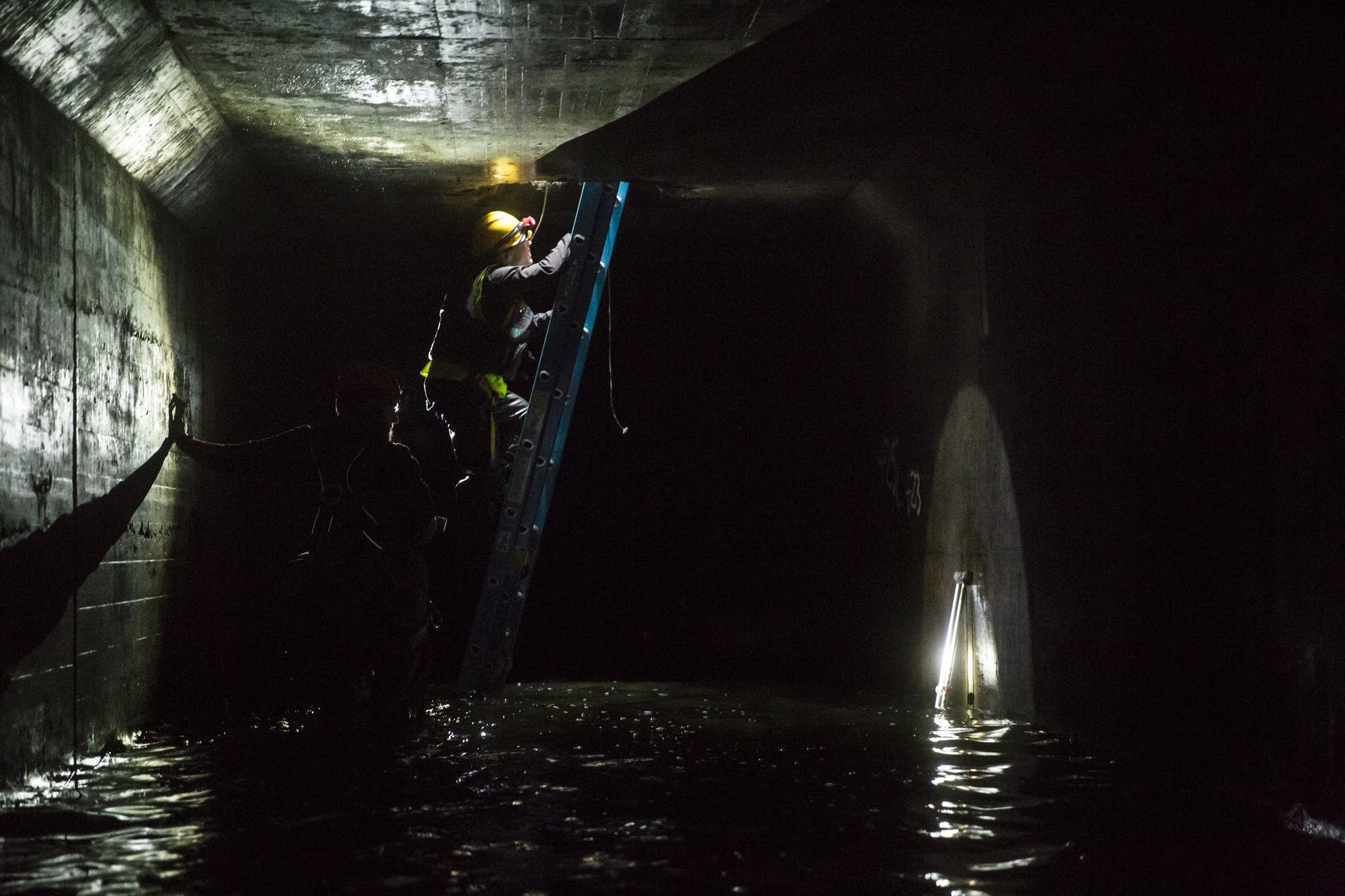 People exit the old Bassett Creek Tunnel