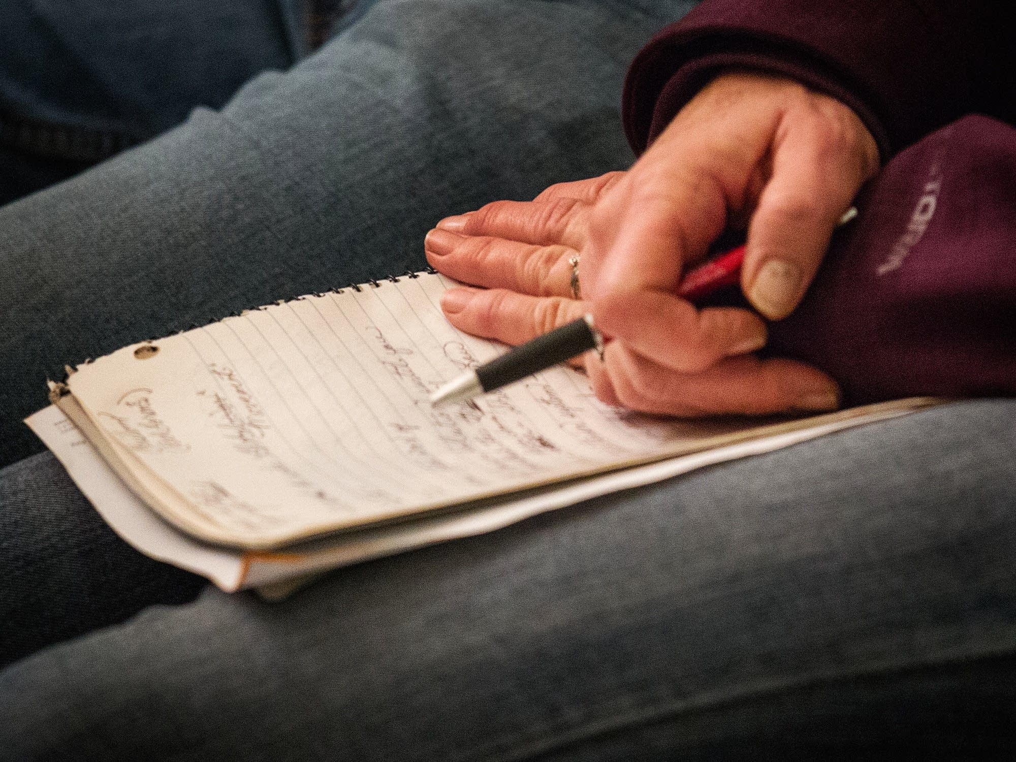 An audience member takes notes.