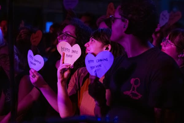 Fans holding up heart-shaped signs