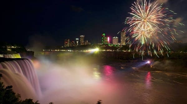 Fireworks set off from the Canadian side light up the sky over Niagra Falls late July 3, 2016, part of the July 4th US Independence Day celebrations, in Niagra Falls, New York.