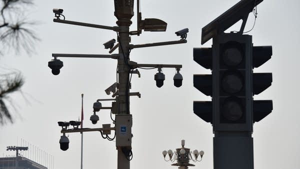 Surveillance cameras are seen on a corner of Tiananmen Square in Beijing in September.