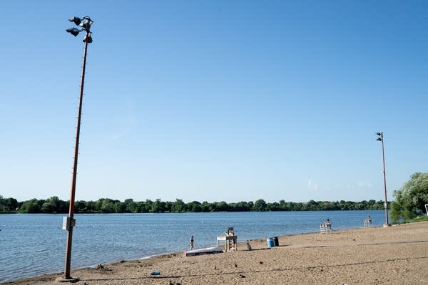 A swimmer gets out of Lake Nokomis on Tuesday.