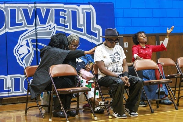 Community leaders and residents gather for a press conference at Folwell Park
