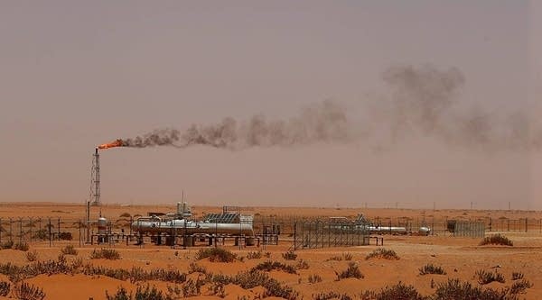 A flame from a Saudi Aramco oil installation known as 'Pump 3' is seen in the desert near the oil-rich area of Khouris.