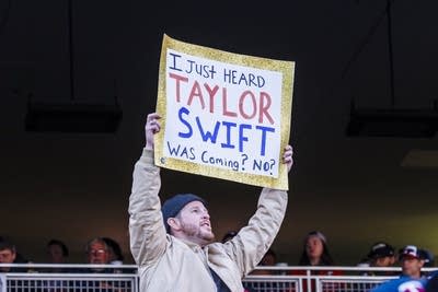 A fan holds a sign