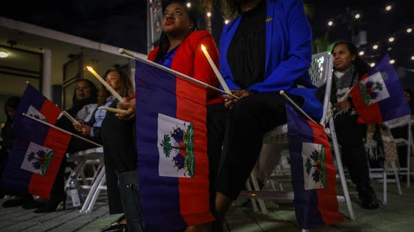 Above, people attend a candlelight vigil for Haitians living in the U.S. with Temporary Protected Status in Miami, Florida on February 3. Florida's economy could take a hit from the loss of TPS for Haitian workers.