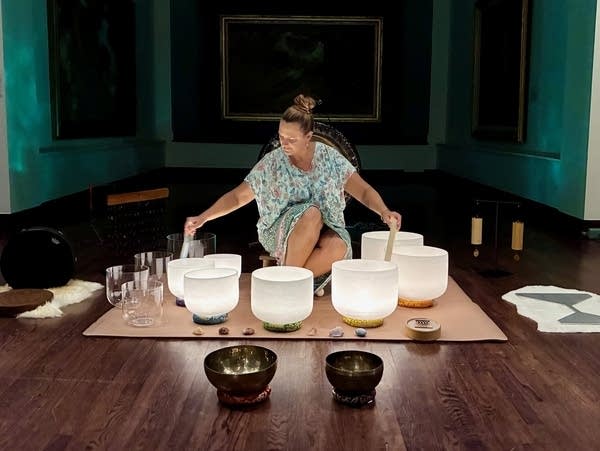 woman playing crystal bowls