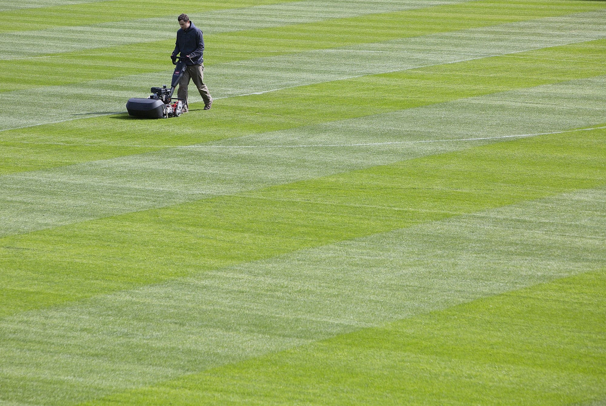 Assistant groundskeeper Mitch Ronning cuts the grass at Allianz Field.