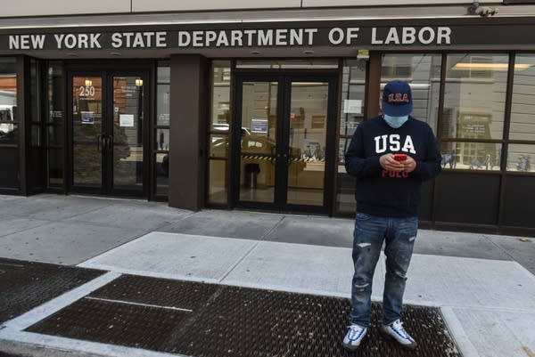 NEW YORK, NY - MAY 07: Luis Mora stands in front of the closed offices of the New York State Department of Labor on May 7, 2020 in the Brooklyn borough in New York City. 3.2 million Americans have filed for unemployment insurance this week bringing the total number of workers who have applied for aid to 33 million in the past two months. (Photo by Stephanie Keith/Getty Images)