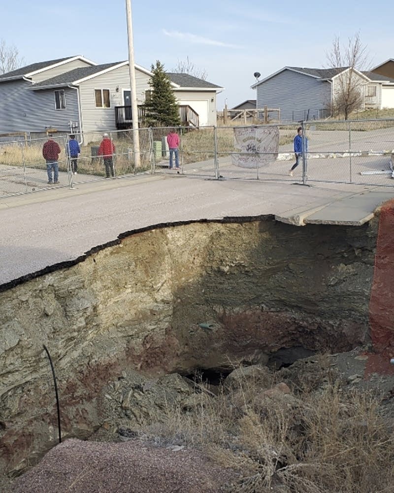Giant sinkholes in a South Dakota neighborhood make families fear