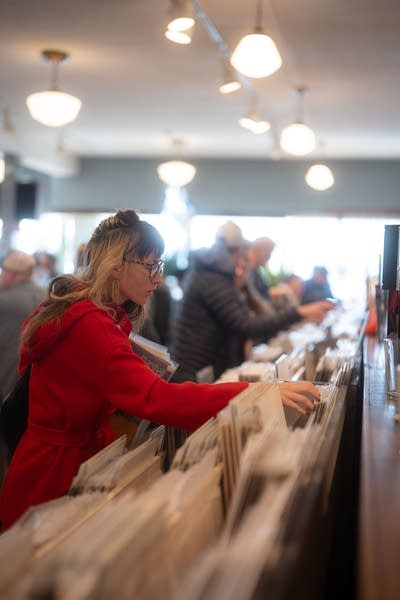People browse records in a record store
