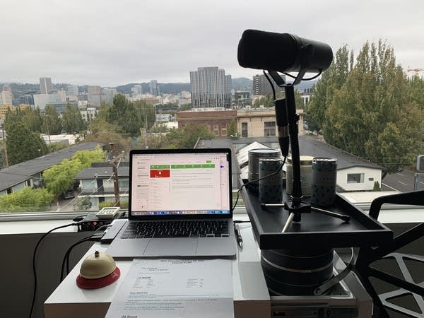 Laptop computer next to a precariously placed microphone in front of window