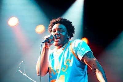 gr3g and his band performing on stage