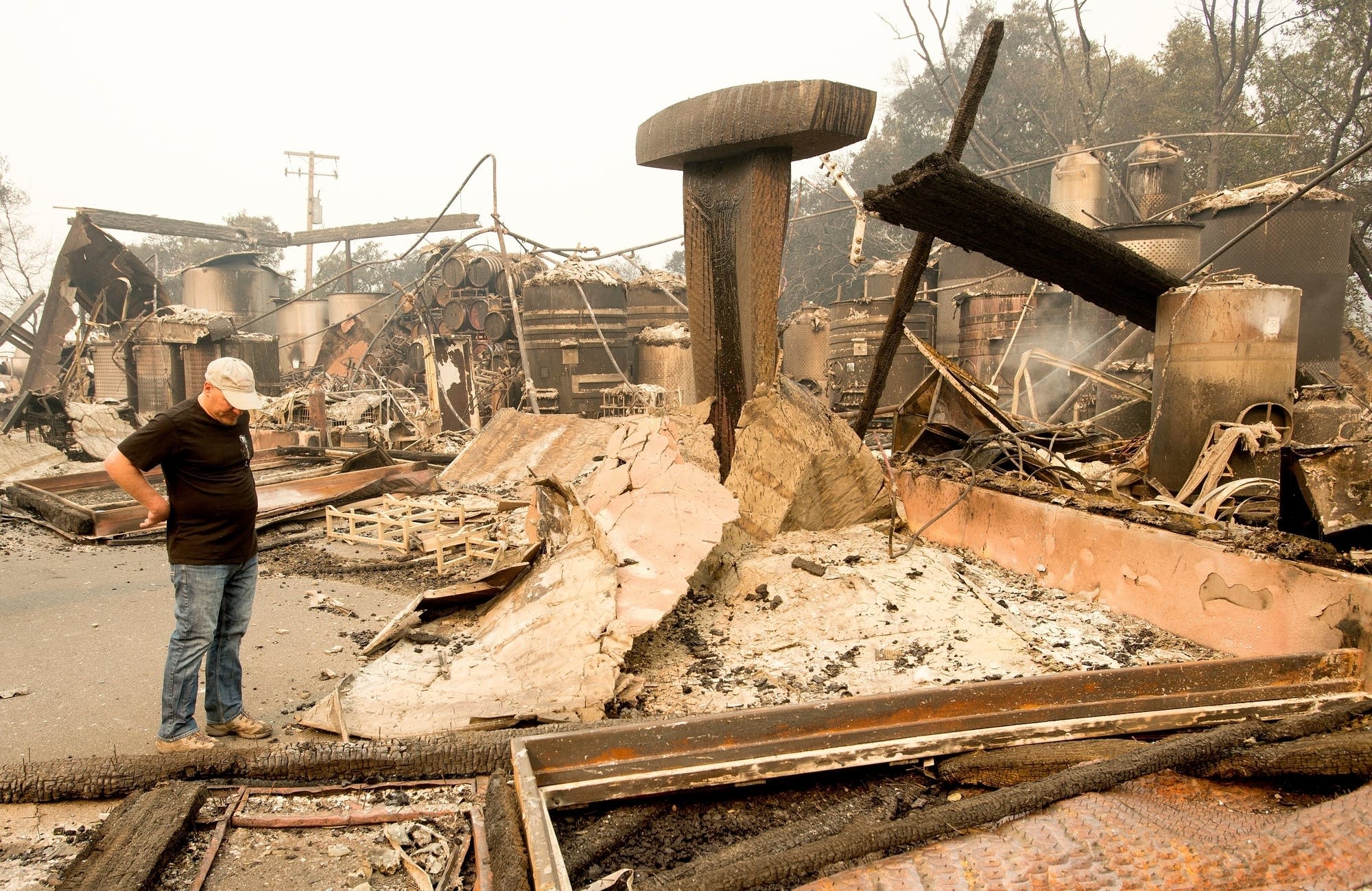 Rene Byck looks over remains of his Paradise Ridge Winery.