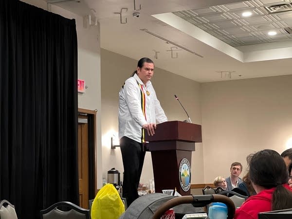 A man stands at a podium to speak.