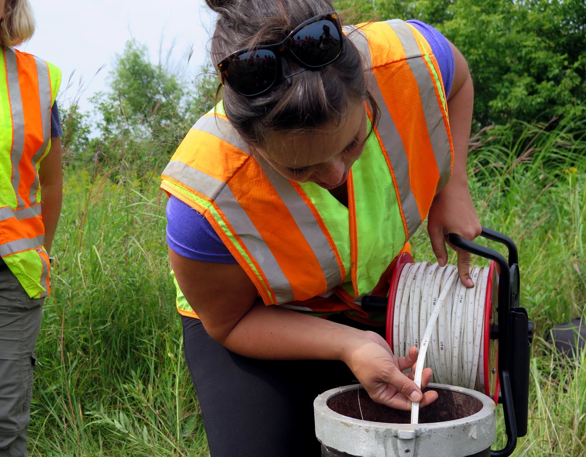 DNR hydrologist Erynn Jenzen uses an electronic tape measure.