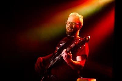 A musician plays bass onstage 