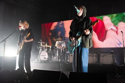 Three musicians performing onstage