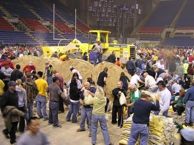 Volunteers fill sandbags at the Fargodome Sunday