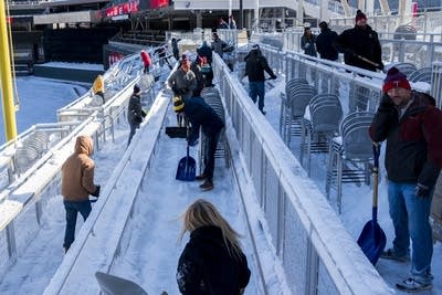 Spring snow is shoveled off of the Great Clips Great Seats section.