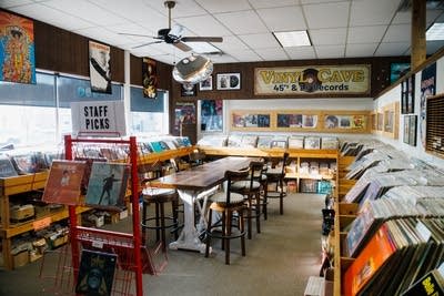 A room filled with shelves of vinyl records in a record store
