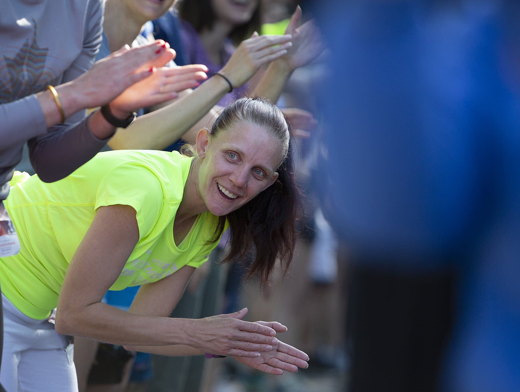 Mile in My Shoes resident member Amy Vorlicky cheers on kids race runners.