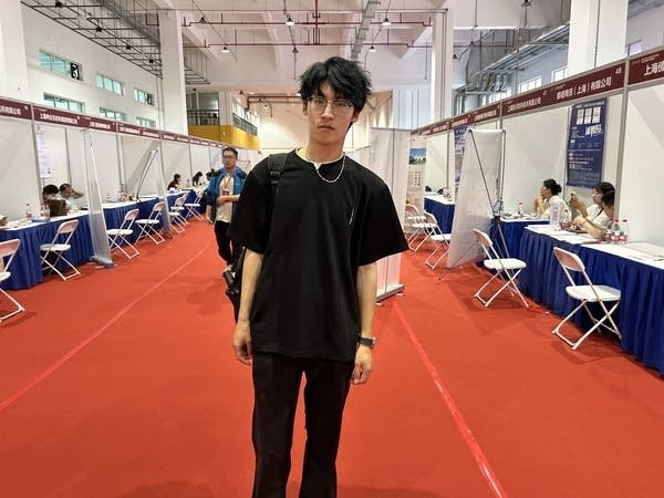 A college graduate poses at a job fair in Shanghai named Gao Shengqi.