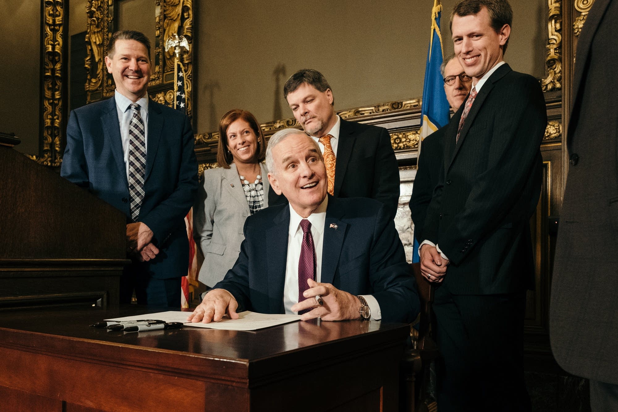 Mark Dayton signs a bill allowing the construction of a new power plant.