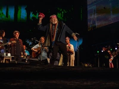 A group of musicians perform on the Farm Aid stage.