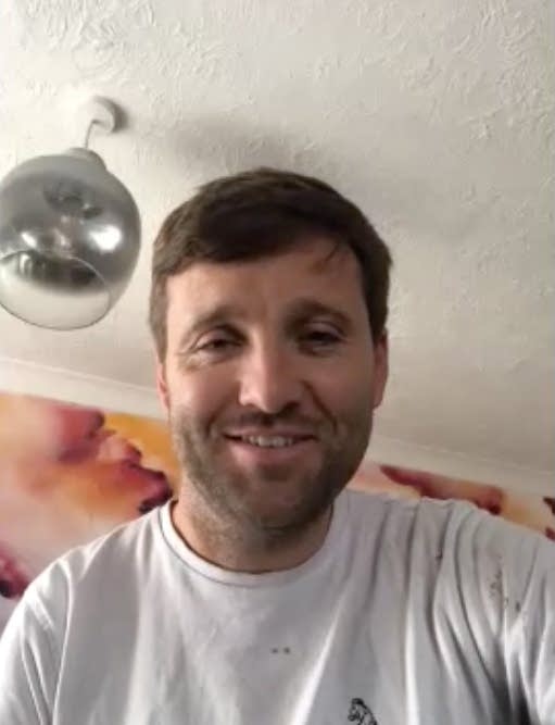 A man smiles during a Zoom conversation