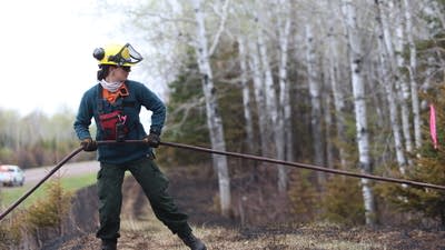 Firefighters work to battle the Stewart Trail wildfire.
