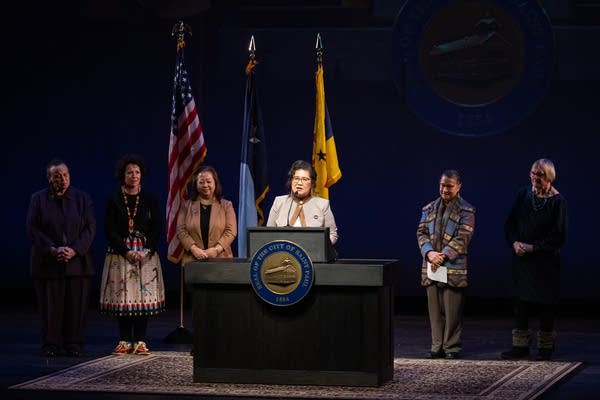 A woman speaks at a podium