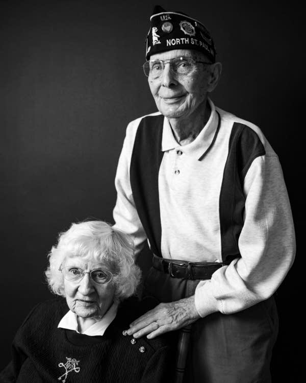 Two people in a black and white portrait.